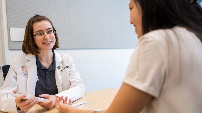 doctor of pharmacy student with patient 