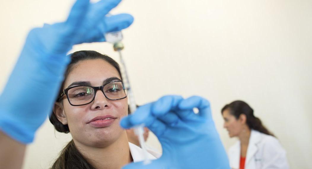 a pharmacy student prepares a flu shot